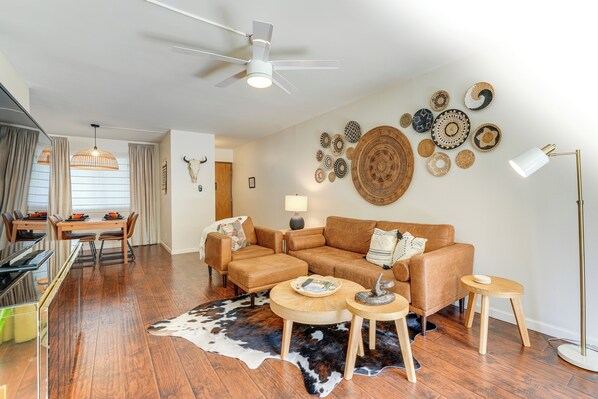 A modern living room with a brown leather sofa, wooden coffee table, and a cowhide rug. - < 1 Mi to Old Town: Scottsdale Condo w/ Balcony (Scottsdale)
