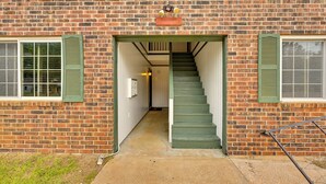 Un bâtiment en briques avec un escalier menant à un étage supérieur.