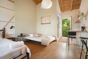 A bedroom with a bed, bedside tables, a desk, and a chair.