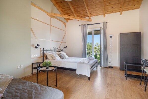 A bedroom with a bed, bedside table, lamp, and wardrobe. - Fairytale Apartment with Sea View, Wi-Fi, and Air Conditioning (Lefkada)