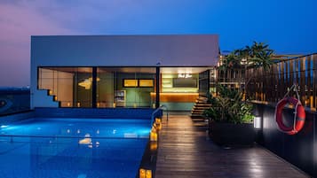 A modern building with a pool and a bar area.