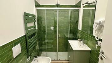 Monolocale Deluxe, 1 letto matrimoniale con divano letto, bagno privato | Bagno | Doccia, asciugacapelli, asciugamani, sapone