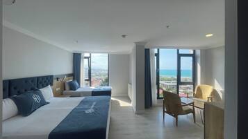 Triple Room, Sea View | Desk, laptop workspace, soundproofing, iron/ironing board