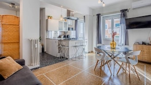 Un appartement moderne comprenant une cuisine, un coin repas et un salon.