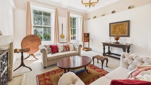 A spacious living room with a sofa, armchairs, a coffee table, and a fireplace. - Host Stay Thornecroft (Knaresborough)