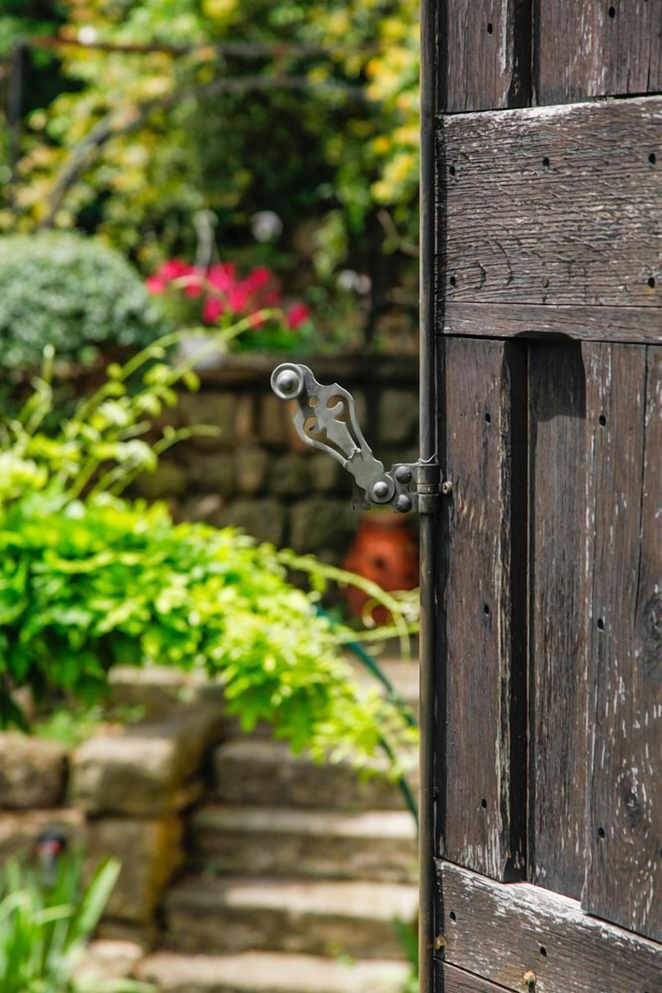 A wooden door with a metal latch.