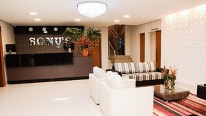 A modern hotel lobby with a reception desk, sofas, and a staircase. - Sonus Hotel (Sinop)