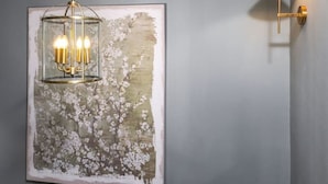 A room with a gray wall, a framed abstract painting, a hanging light fixture, and a wall-mounted lamp. - The Nevis Suite at Munro Guest House (Stirling)