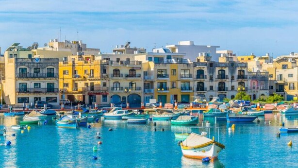 A marina with numerous boats docked, surrounded by colorful buildings. - Charming home Apt with private balcony in B`Bugia (Birżebbuġa)