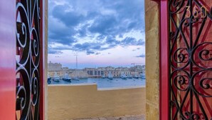 A view of a harbor with boats and buildings. - Maltese Maisonette in Historic Isla with Sea Views (L-Isla)