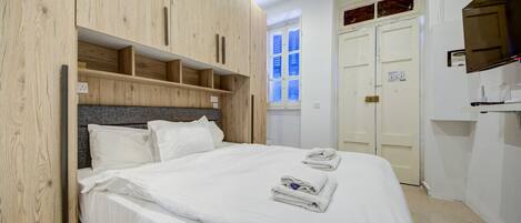 1 bedroom, desk, iron/ironing board, travel crib