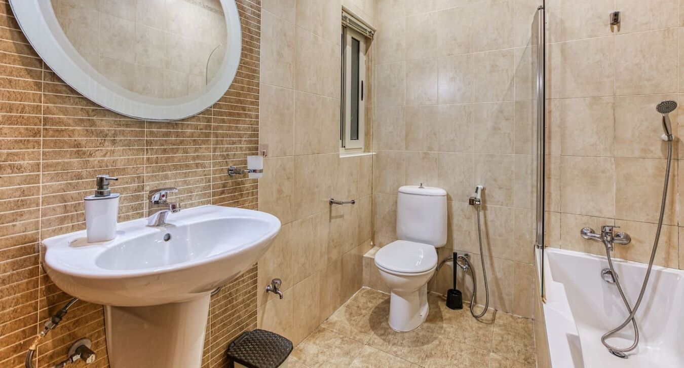 A bathroom with a sink, toilet, and bathtub.
