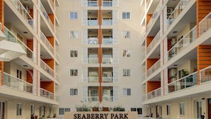 A modern multi-story building with a central entrance labeled "SEABERRY PARK". - Brand new, fully equipped 2BR home in Qawra (San Pawl il-Baħar)