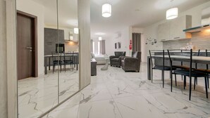 A modern interior with a dining area, kitchen, and living space. - Cosy 1BR home with full amenities in central Gzira (Il-Gżira)