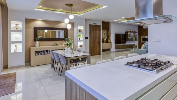 A modern kitchen with a central island, pendant lighting, and a built-in stove. - 2BR Home in Mosta with Terrace & Vineyards View! (Il-Mosta)
