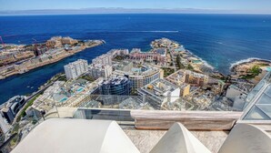 A high-rise hotel with a panoramic view of the coastline and ocean.