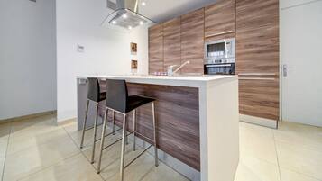 Una cucina moderna con isola centrale, elettrodomestici in acciaio inossidabile e un design minimalista.
