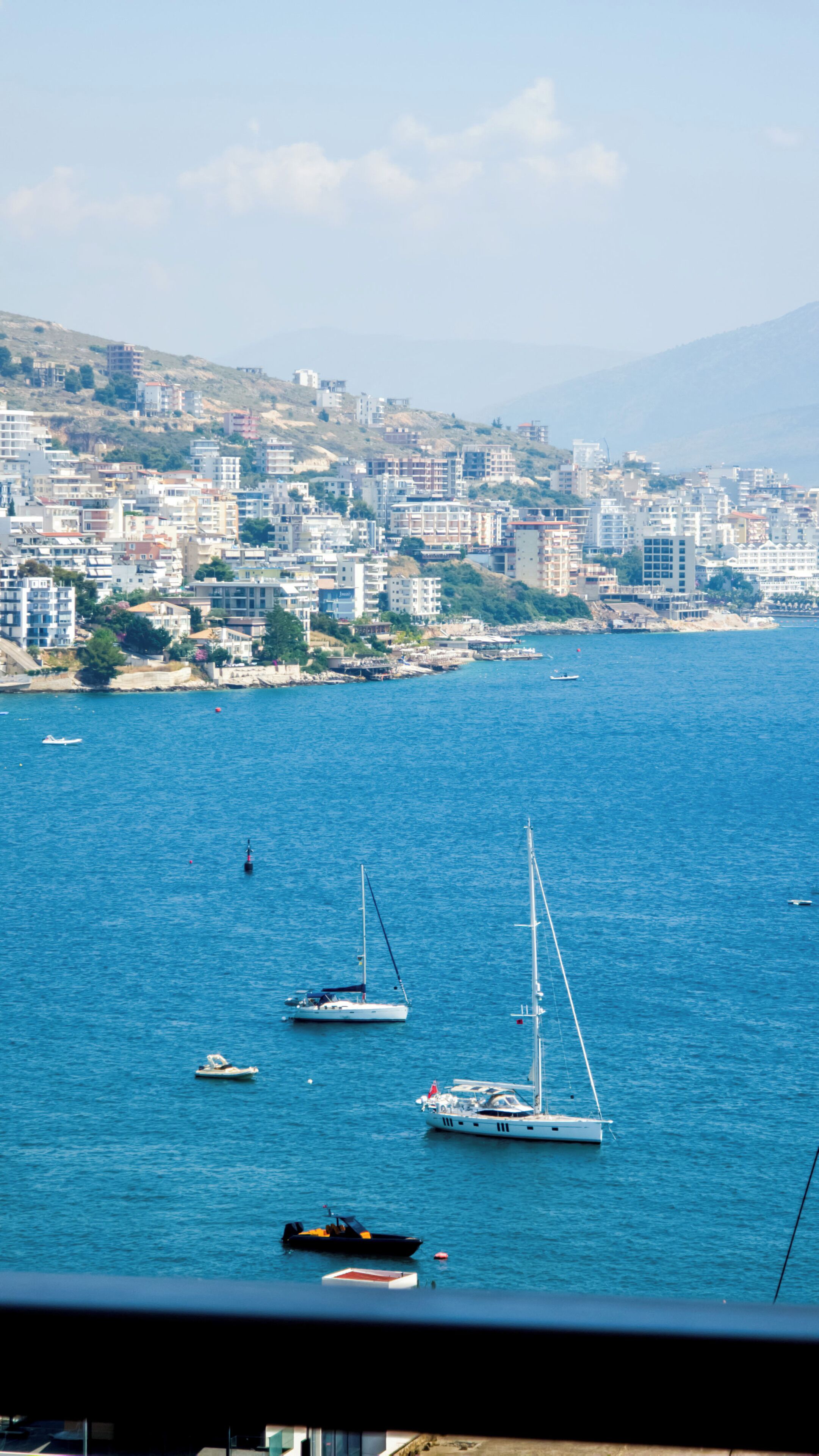 A coastal cityscape with buildings and a marina.