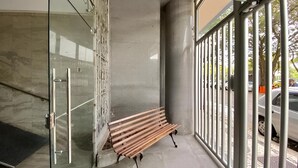 A bench outside a building with large windows and a glass door. - SUH Flamengo 08 Live in Aterro (Rio de Janeiro)