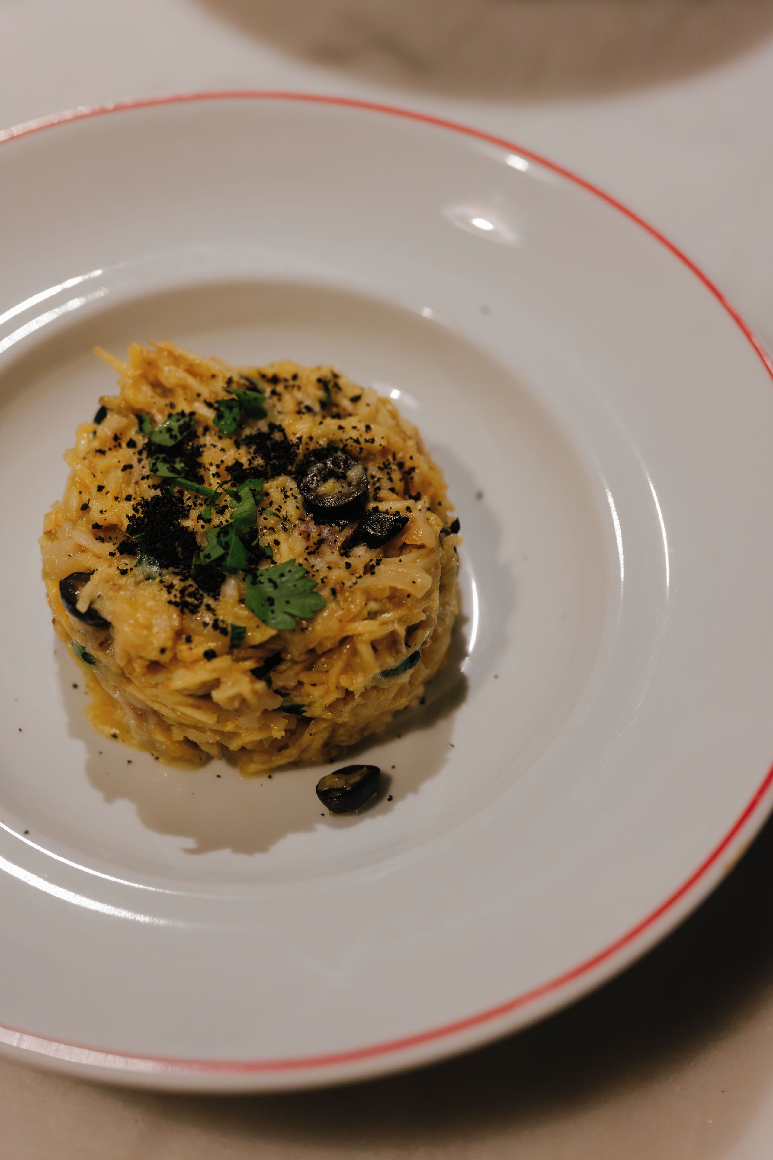 A plate of food with a red rim.