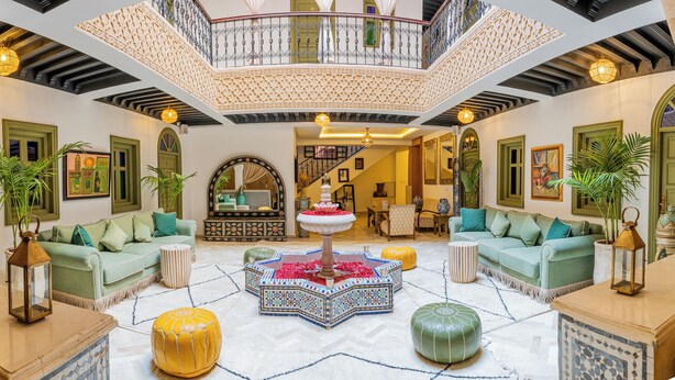 A spacious lobby with a high ceiling, a central fountain, and multiple seating areas. -  Riad Hamdane Rooftop & SPA  (Marrakech)