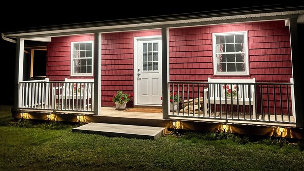 A two-story house with a red exterior, white trim, and a front porch with a railing. - Cozy Country Cottage in Sullivan County Catskills. 2 Bedrooms, 1 Bath, Heat & AC (Ferndale)