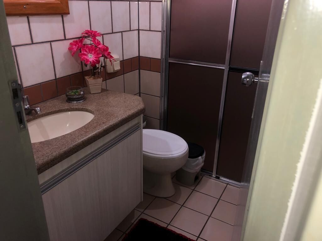 A bathroom with a sink, toilet, and shower.