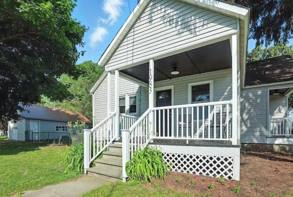 A single-story house with a covered porch and a small front yard.