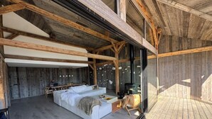 A modern interior with a wooden ceiling, a sofa set, and a fireplace.