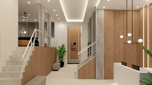 En moderne hotellobby med en central receptionsdisk, en trappe med træbeklædning og et minimalistisk design.