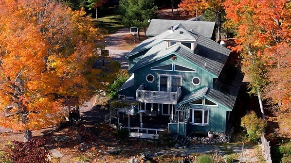 A large house with a prominent front porch and multiple windows.