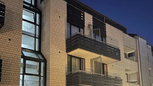 A multi-story residential building with a brick facade, large windows, and a balcony. - Exklusiv | Küche | Office | Streaming+Minibar 6311 (Bonn)