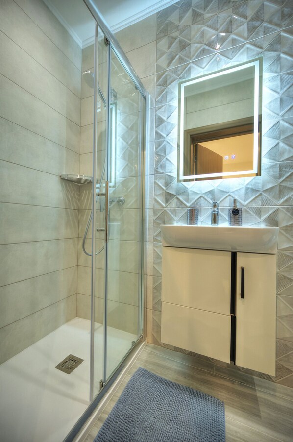 Shower, hair dryer, towels, soap