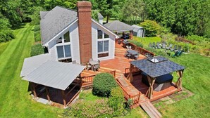 A large house with a deck, a covered patio, and a small shed. - 7BR Monroe Getaway: Pool, Hot Tub, & Huge Living Space (Monroe)
