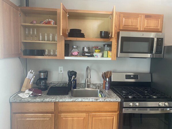 Fridge, microwave, stovetop, coffee/tea maker