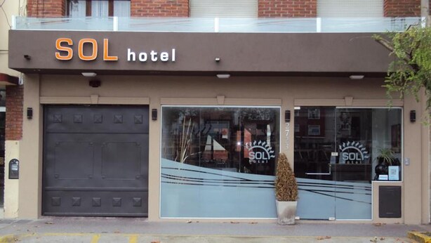 The exterior of SOL hotel with a large garage door, a potted plant in front, and a clear view of the entrance. - Hotel Sol (Mar del Plata)