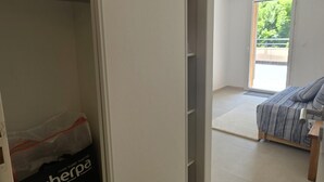 A room with a bed, a wardrobe, and a window.