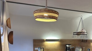 A kitchen with a wooden countertop, a hanging light fixture, and a coffee machine. - 60 sqm apartment on the ground floor with garden and courtyard for 2 people (Michelau in Oberfranken)