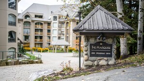 A stone sign with "The Marquis" and "4809 Spearhead Drive" indicating a hotel location. - Ski-in/Ski-out | Pool & Hot Tub | Sleeps 5! (Whistler)