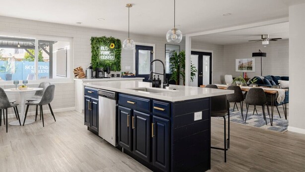 A modern kitchen with a central island, built-in appliances, and a dining area with a view. - Ultimate Scottsdale Getaway | Heated Pool & Fire Pit | Game Room (Scottsdale)