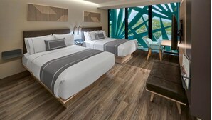 A modern hotel room with two beds, a small desk, and a large window with a view of greenery. - Walk to Everything from Your Mérida Rooms - 4 Units (Mérida)