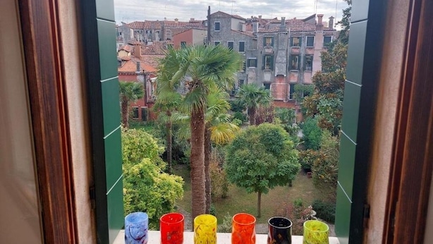 Varanda com vista para uma área residencial, incluindo edifícios e árvores.