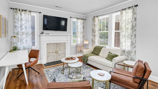 A living room with a fireplace, a television, and a sofa.