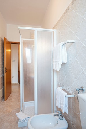 Klassiek appartement | Badkamer | Een haardroger, een bidet, handdoeken, zeep
