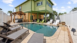A two-story house with a swimming pool, outdoor seating, and a pergola. - Seaside Escape  Walk to Beach  Private Pool + Hot Tub (Panama City Beach)
