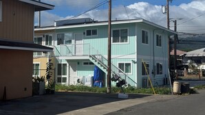 A two-story building with a balcony, a staircase, and a laundry area. - Kalihi Stream, Coffee Bar, Ro Water, Split Ac, WIFI, Black Out Curtain, 4Parking (Honolulu)