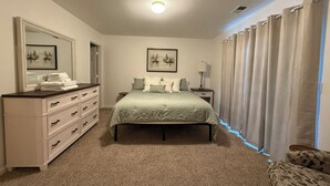 A bedroom with a bed, dresser, and two framed pictures on the wall. - Charming 3-bedroom house with AC, WiFi in fantastic Susanville (Susanville)