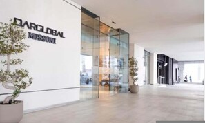 A modern building with a glass facade and a sign reading 'DARGLOBAL MISSION'.