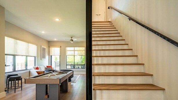 A modern living room with a pool table, a sofa, and a dining area. - DT Designer Gem |  FirePit, Pool Table, Telescope (Fort Worth)