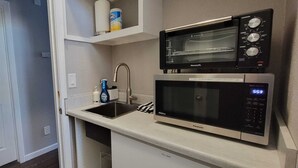 A compact kitchen with a sink, a microwave, and a toaster. - Easy access to I-5, Hwy 99. 1 bus stop from Aurora Transit Center. (Edmonds)
